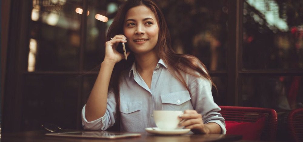 Think Cirrus/young lady on mobile phone with a cup