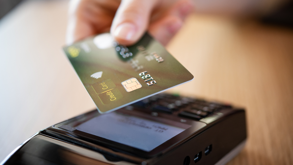 Card payment terminal in use at a restaurant where PCI DSS compliance applies